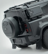 Full rear shot of a Land Rover Defender equipped with the PLUMB heavy-duty bumper and integrated step for enhanced off-road utility.